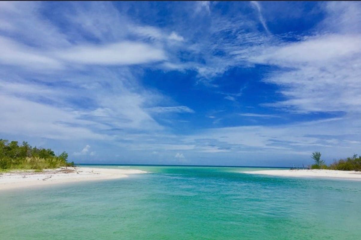 Turquoise water flowing between white-sand barrier islands near Marco Island